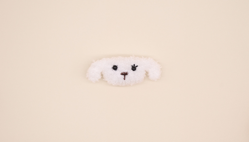 TESTA DI CAGNOLINO CON TESSUTO RICCIOLO